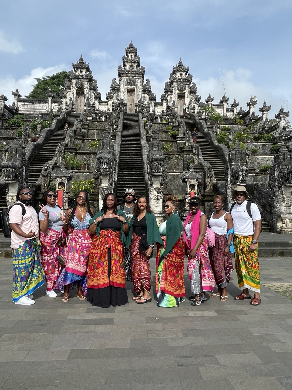 A travel group gathered together in front of an ornate temple