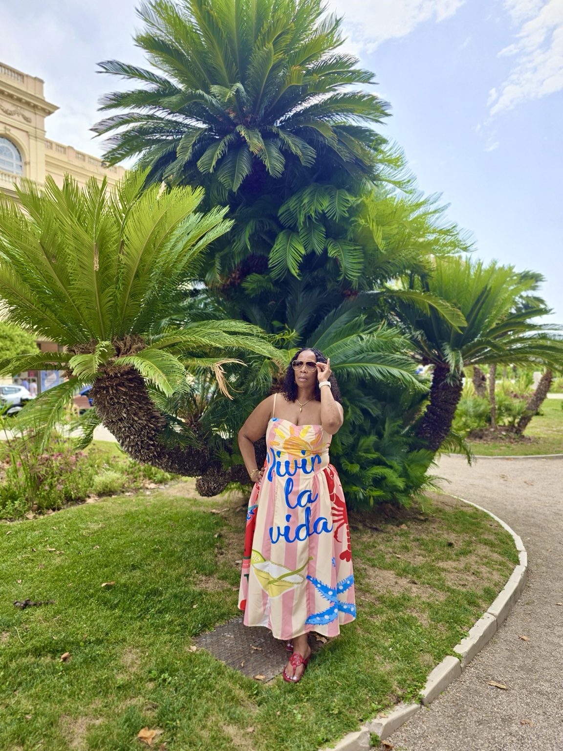 Wendy, founder of Where’s Wendy Destinations, traveling in a colorful summer dress